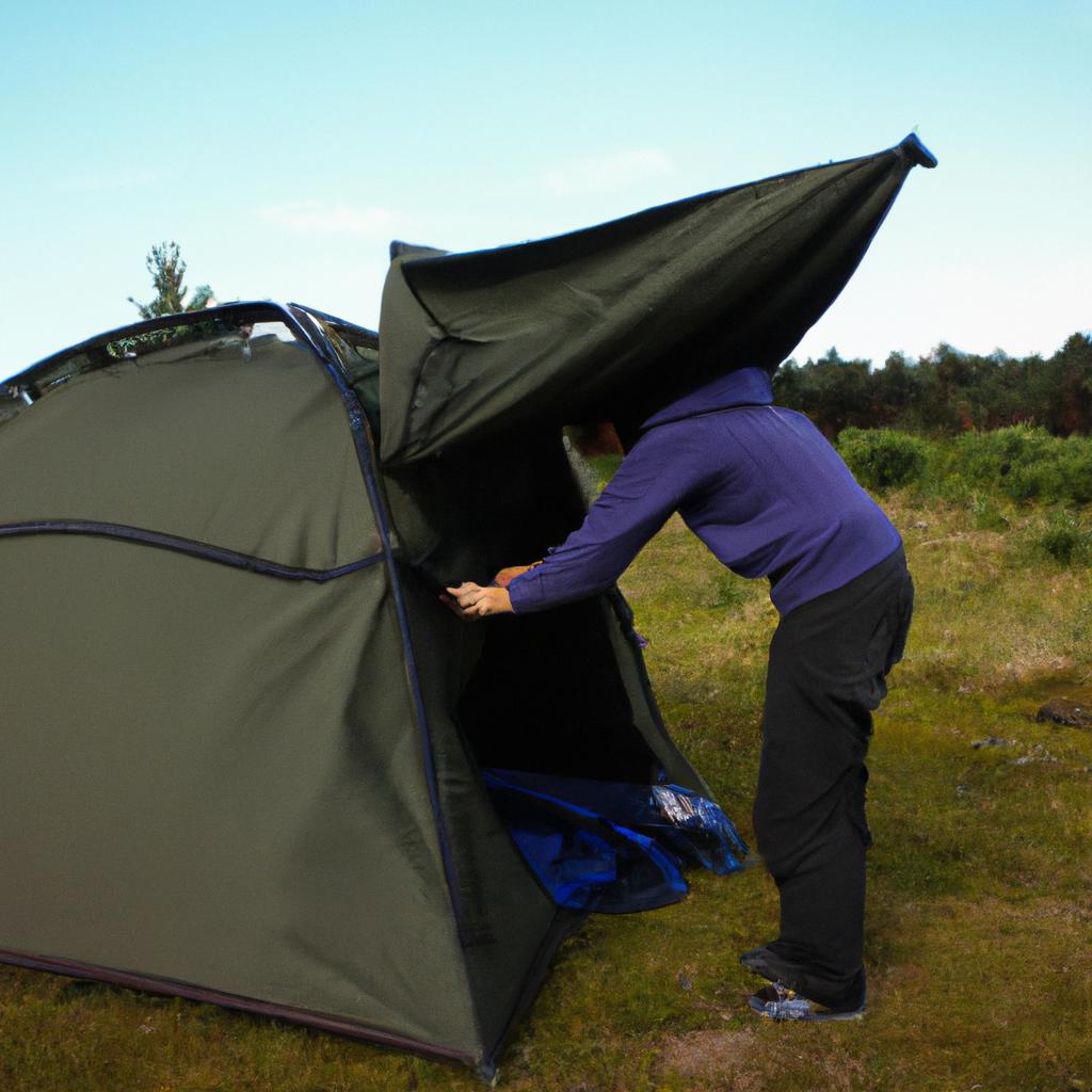 Person setting up camping tent