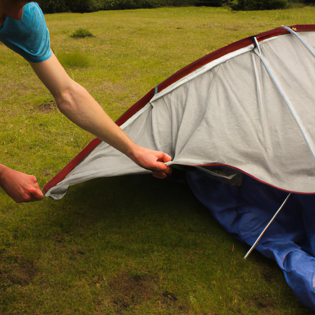 Person setting up a tent